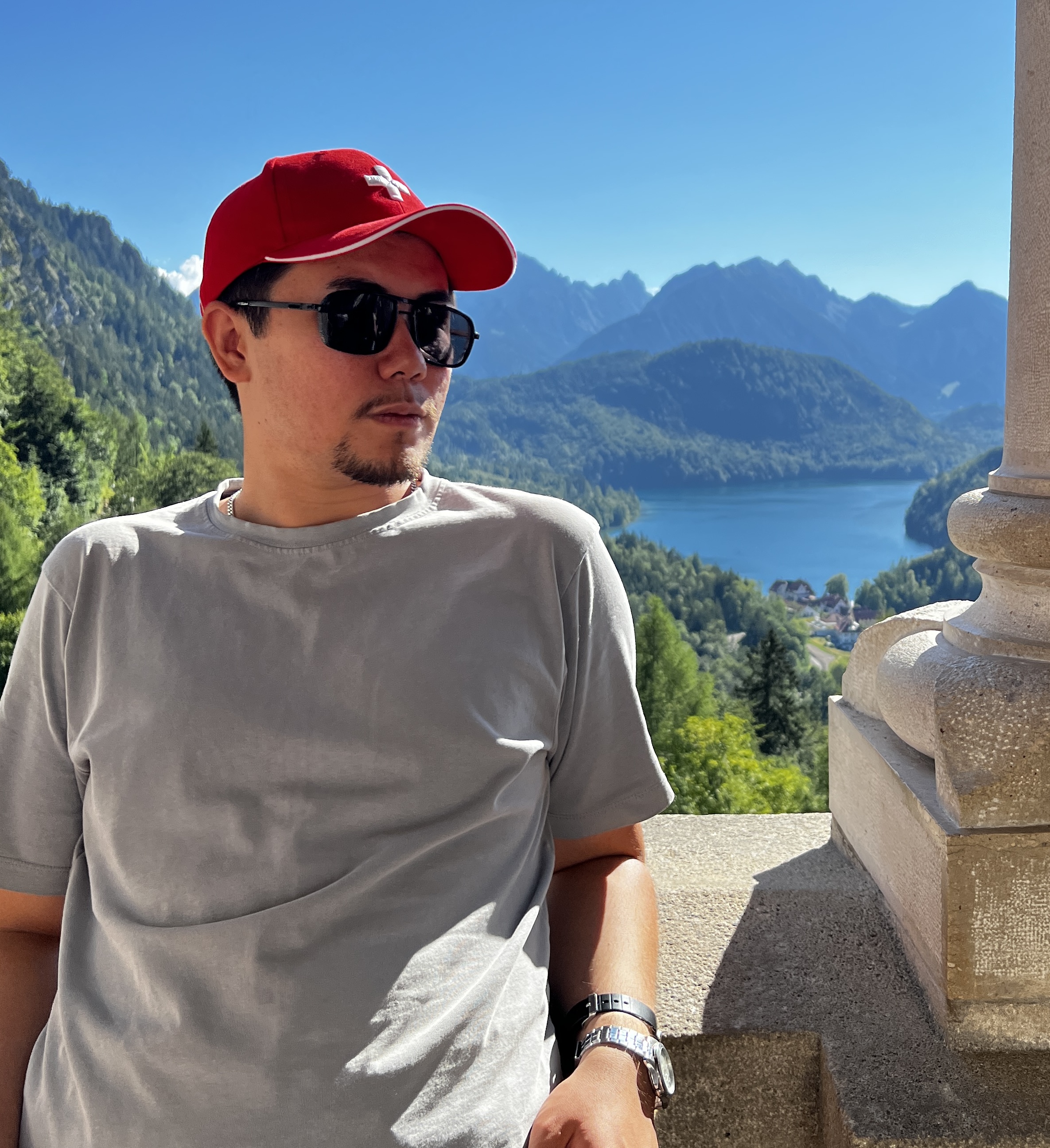 Batyrbek overlooking a mountain lake while travelling