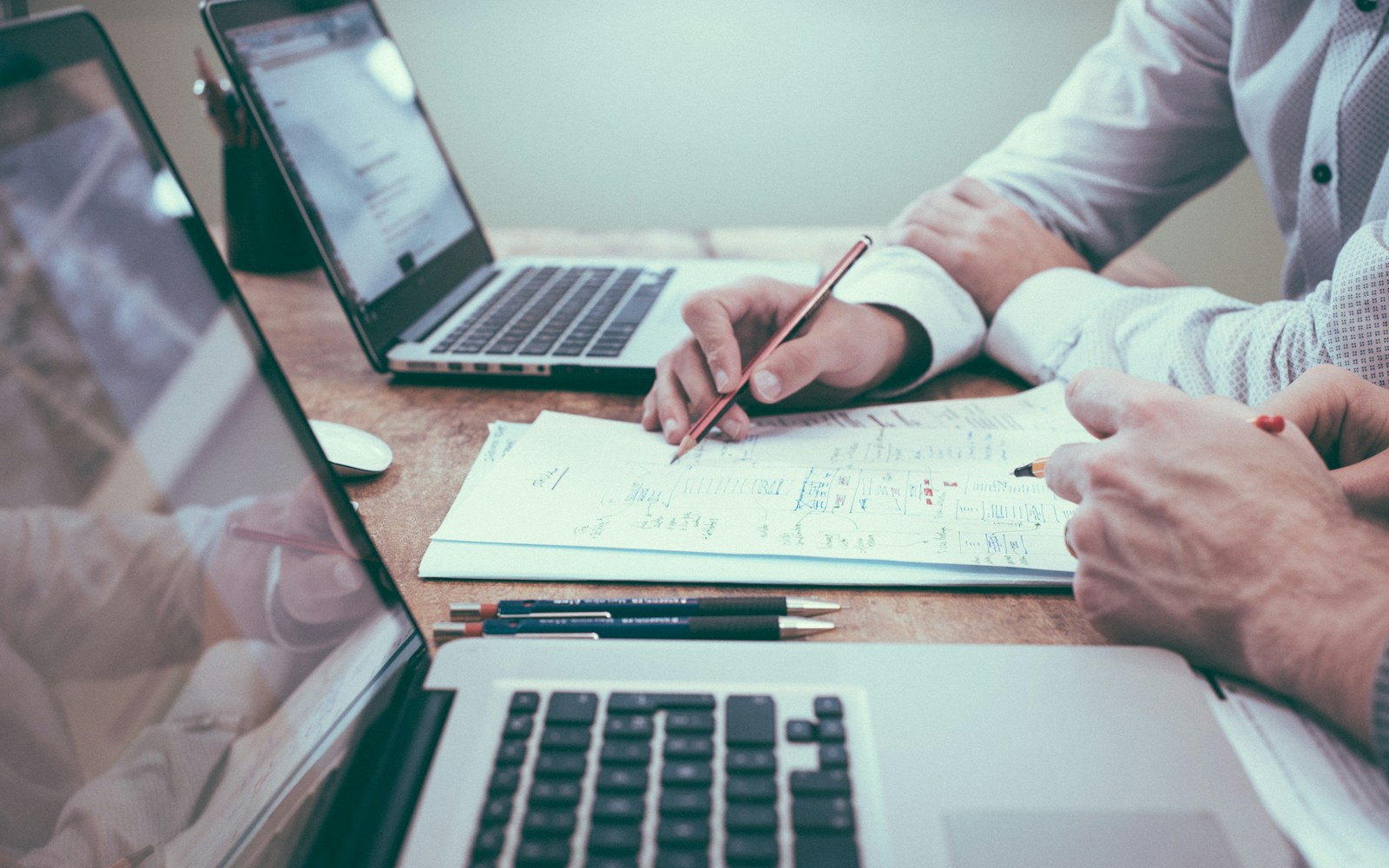 A desk with documents and a laptop, used as a temporary editorial visual for this internal workflow project.